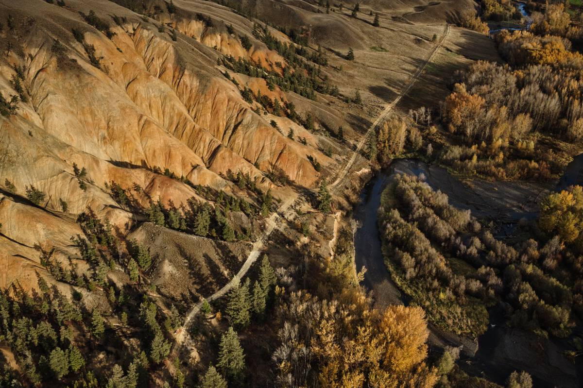 Aerial view of rocky hills in warm, taupe and rust tones.